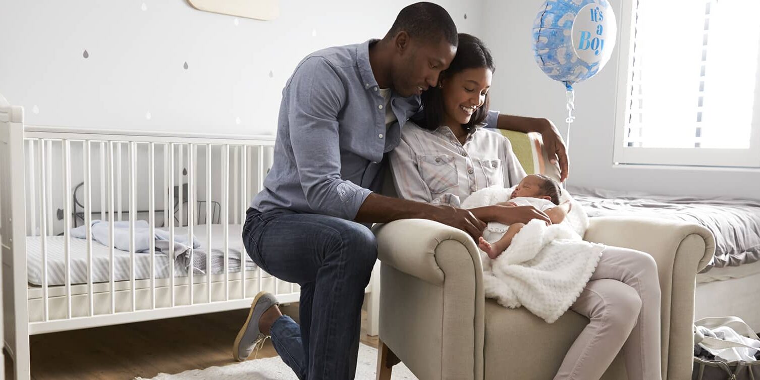 Parents Home from Hospital With Newborn Baby In Nursery